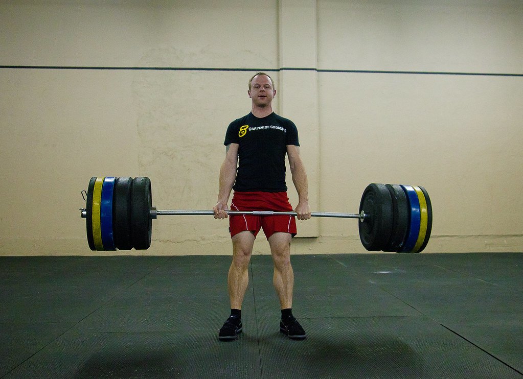 Placeholder image — barbell loaded with iron plates
